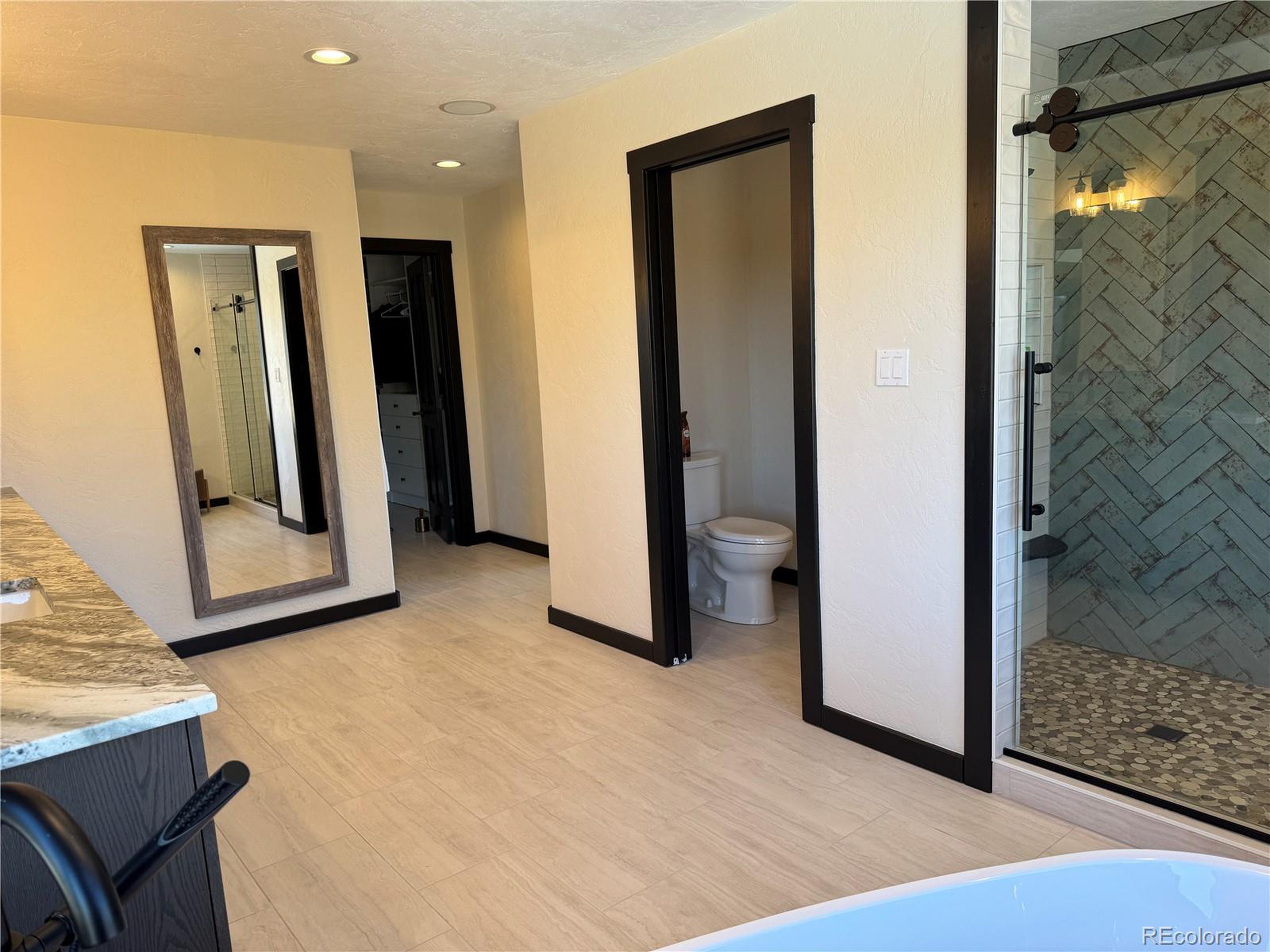 680 Ridge Road Westcliffe, CO 81252 - Photo 7 of 46 a view of a hallway with wooden floor and a bathroom