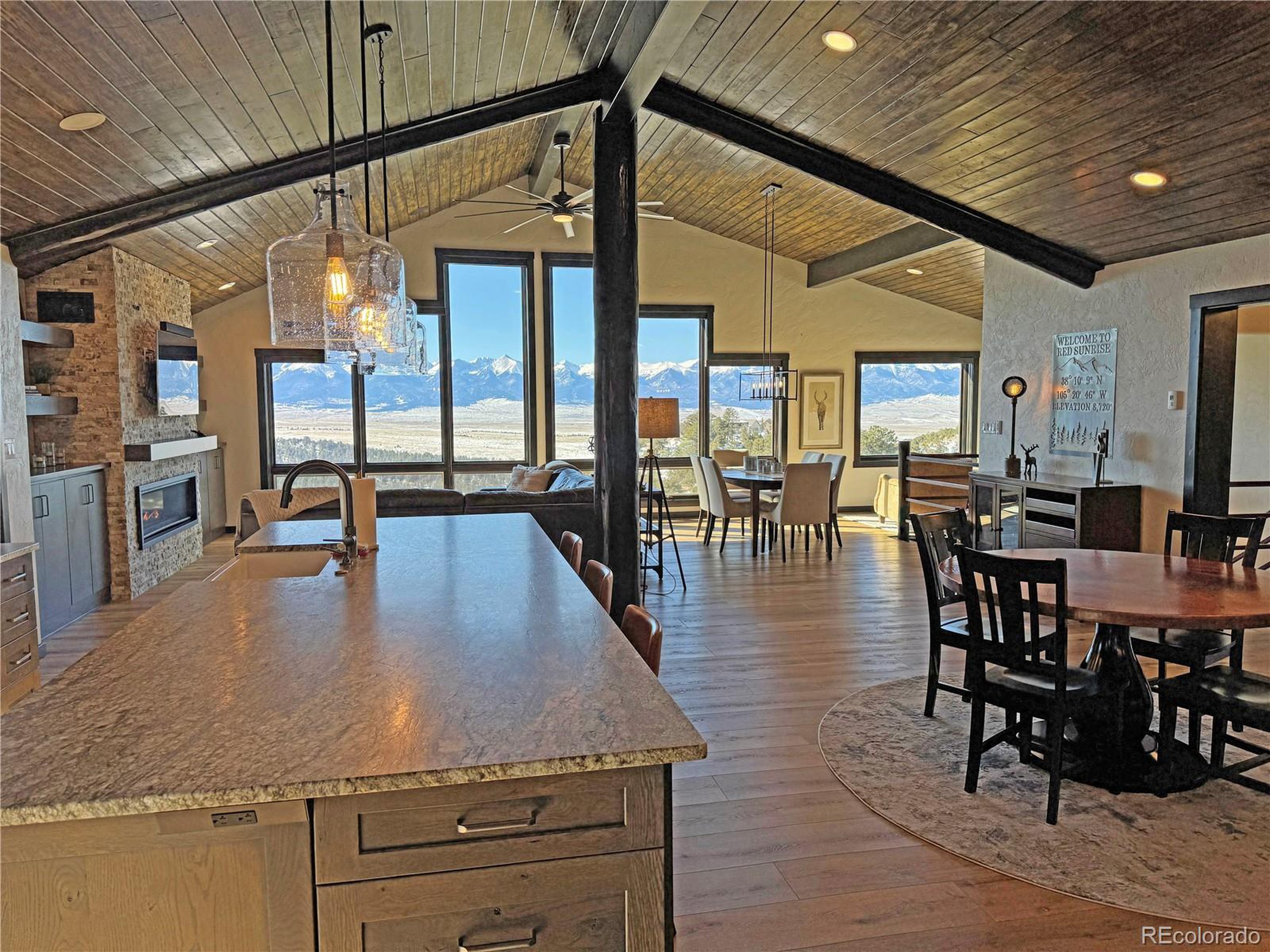 680 Ridge Road Westcliffe, CO 81252 - Photo 9 of 46 a kitchen with stainless steel appliances granite countertop table chairs and a wooden floor