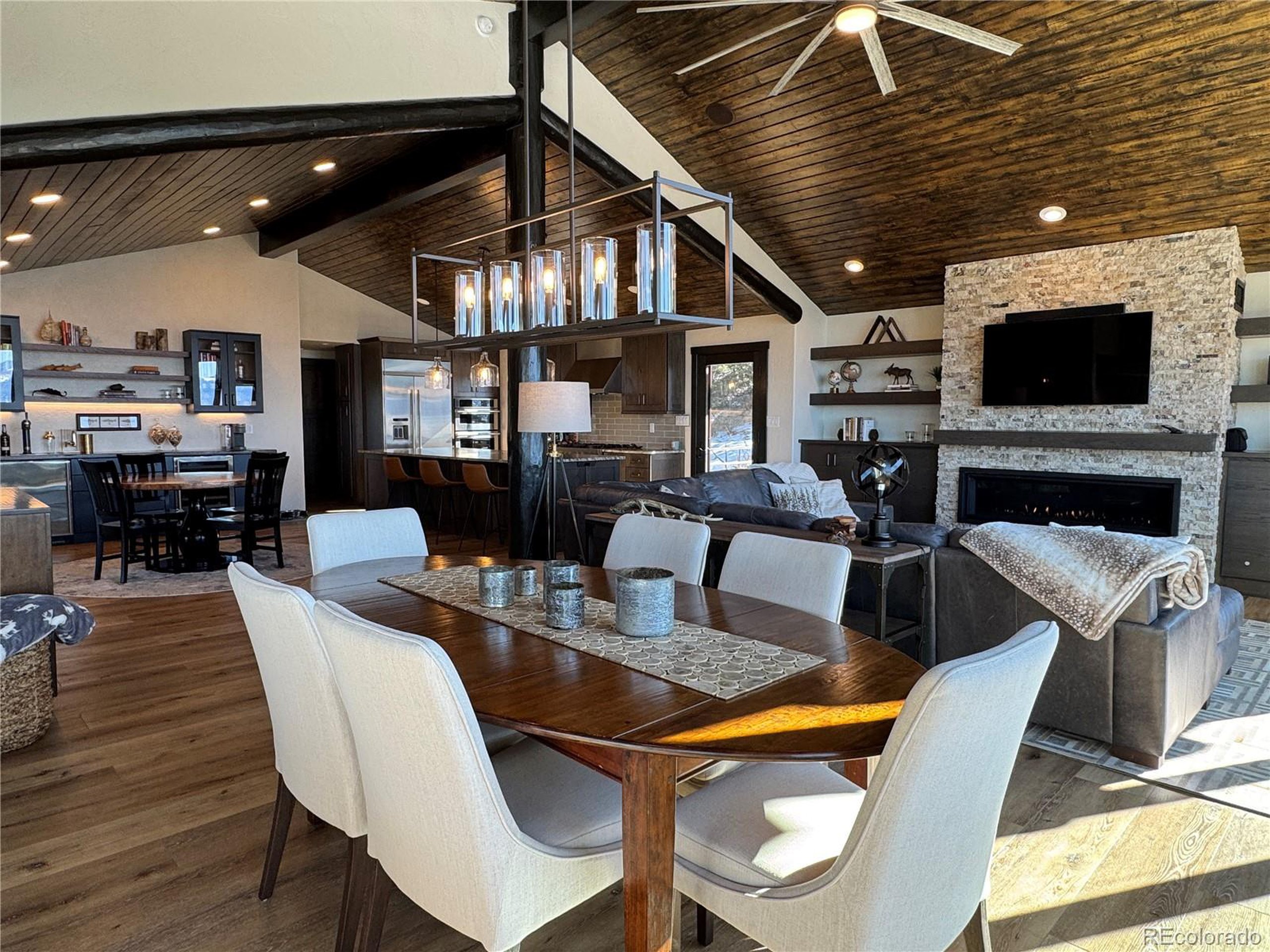 680 Ridge Road Westcliffe, CO 81252 - Photo 10 of 46 a living room with furniture a flat screen tv and a fireplace