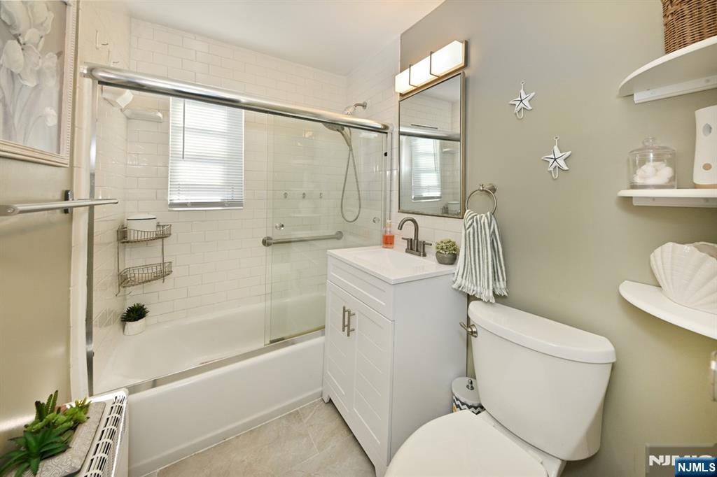 483 Colonial Terrace, Unit 9 Hackensack, NJ 07601 - Photo 12 of 25 a bathroom with a sink toilet and shower