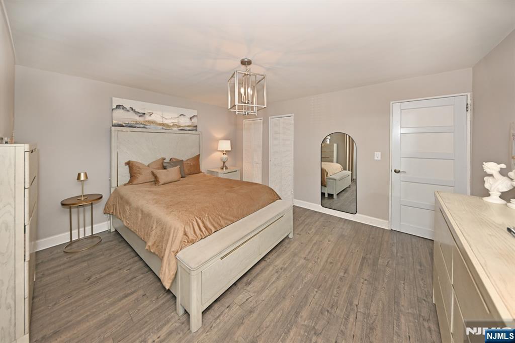 483 Colonial Terrace, Unit 9 Hackensack, NJ 07601 - Photo 14 of 25 a spacious bedroom with a bed and a table in it