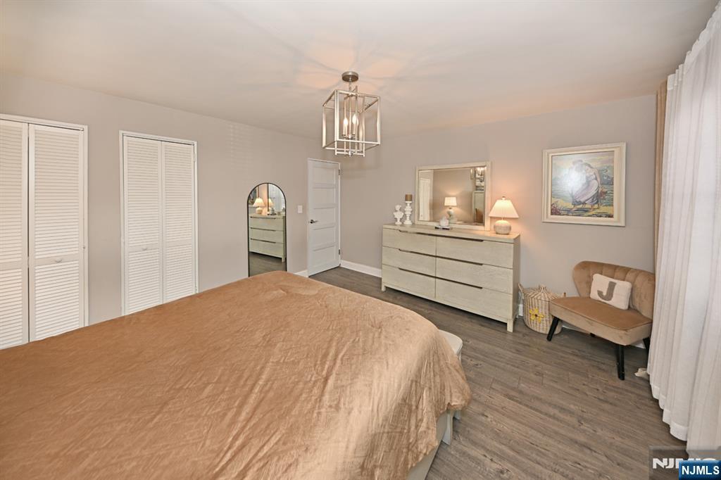 483 Colonial Terrace, Unit 9 Hackensack, NJ 07601 - Photo 16 of 25 a bedroom with a bed and a chandelier