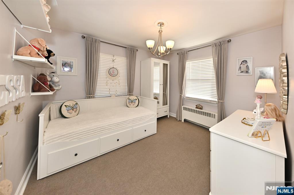 483 Colonial Terrace, Unit 9 Hackensack, NJ 07601 - Photo 17 of 25 a spacious en suite bathroom with a tub double vanity and mirror
