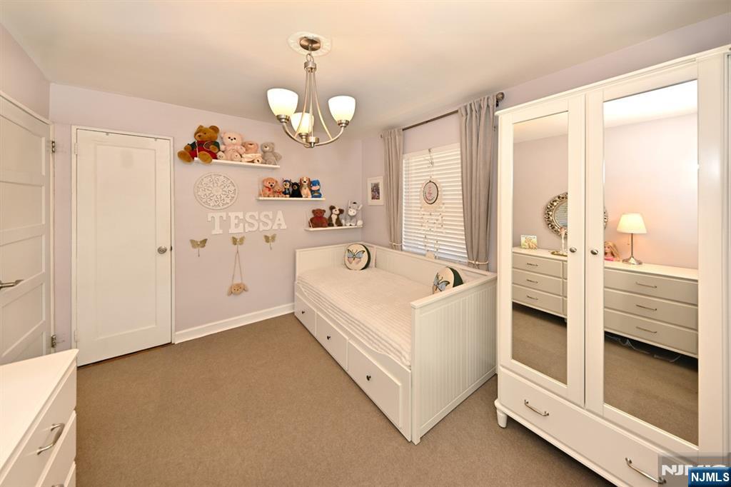 483 Colonial Terrace, Unit 9 Hackensack, NJ 07601 - Photo 18 of 25 a bathroom with a white tub shower and sink