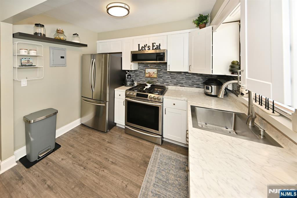 483 Colonial Terrace, Unit 9 Hackensack, NJ 07601 - Photo 10 of 25 a kitchen with granite countertop a refrigerator and a stove