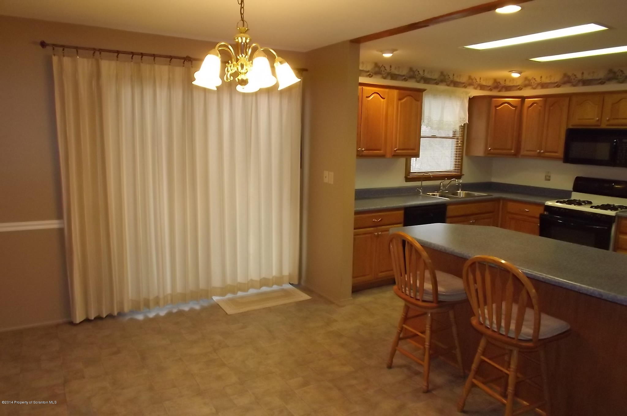 429 Randolph Road Great Bend, PA 18821 - Photo 7 of 33 a kitchen with a table chairs refrigerator and microwave