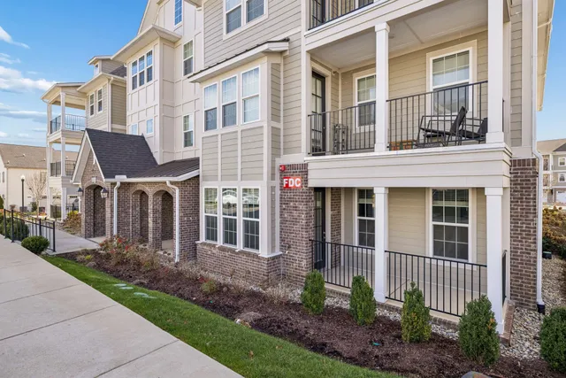 a view of a brick building next to a yard
