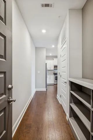 a view of wooden floor and windows in an empty room