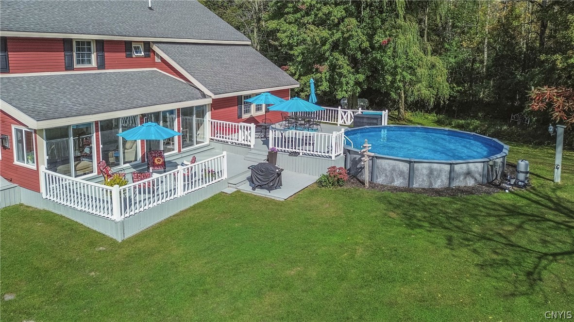 15384 Fuller Road Adams, NY 13606 - Photo 22 of 50 Multi-level wooden decks step down to a lush lawn and an inviting above-ground pool.