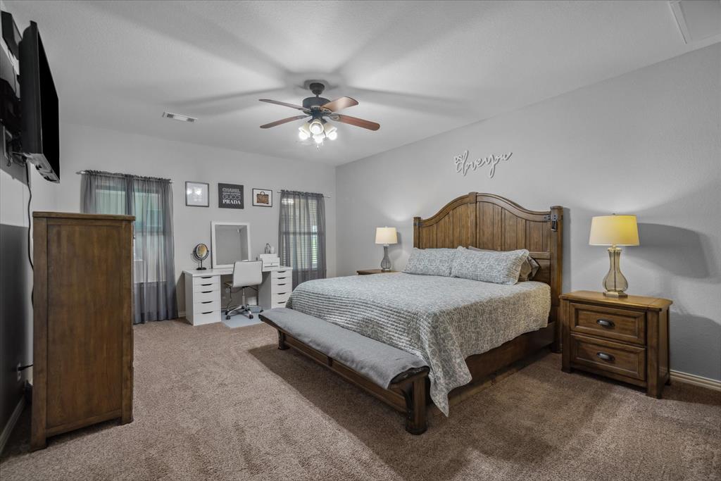 16159 County Road 347 Wills Point, TX 75169 - Photo 19 of 38 a bedroom with a bed dresser and a flat tv screen