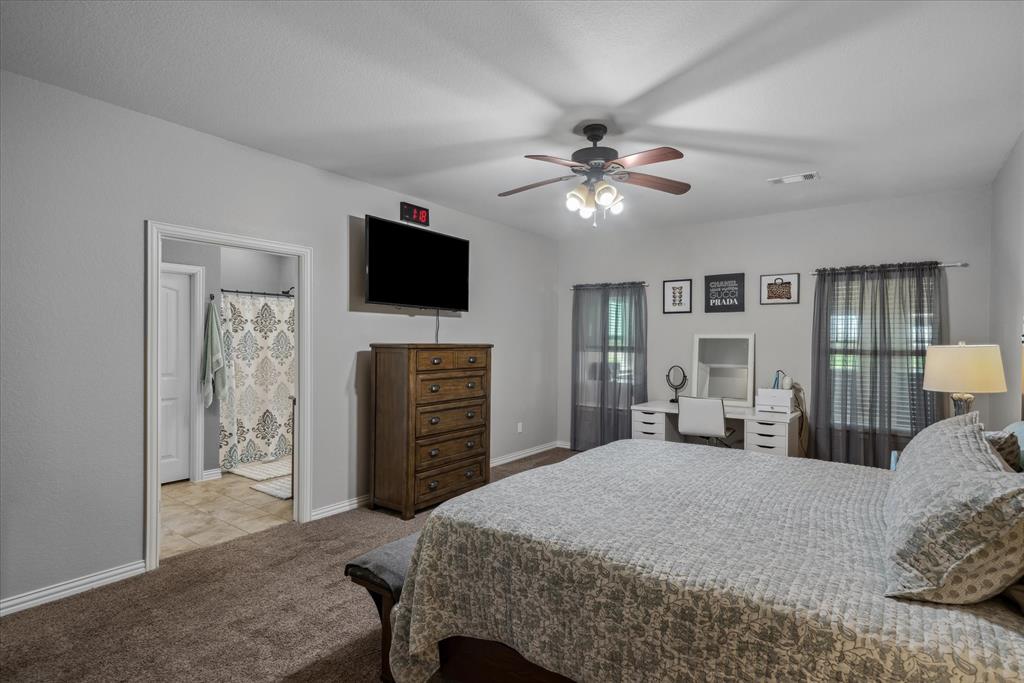 16159 County Road 347 Wills Point, TX 75169 - Photo 20 of 38 a bedroom with a bed and a flat screen tv