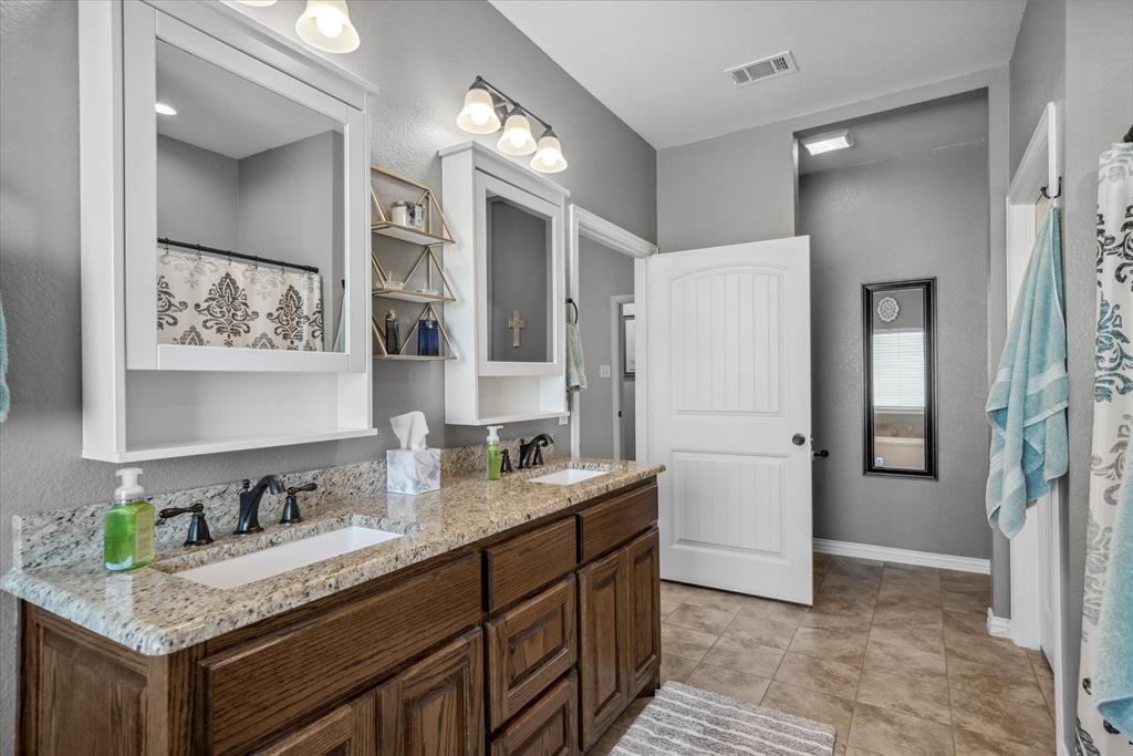 16159 County Road 347 Wills Point, TX 75169 - Photo 22 of 38 a bathroom with a granite countertop sink and a mirror