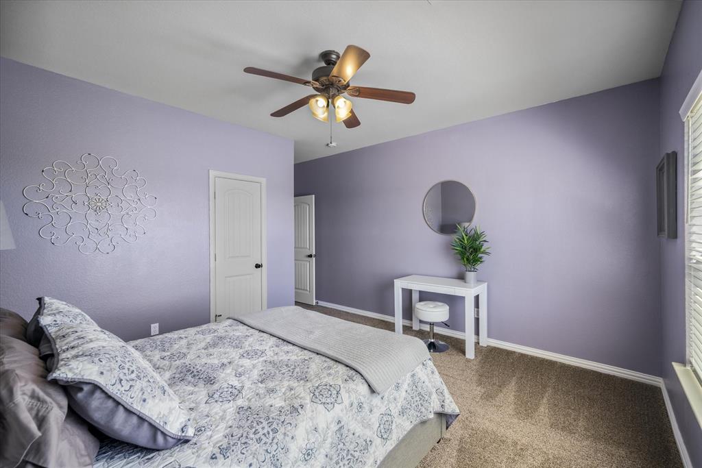 16159 County Road 347 Wills Point, TX 75169 - Photo 24 of 38 a bedroom with a bed and a chandelier