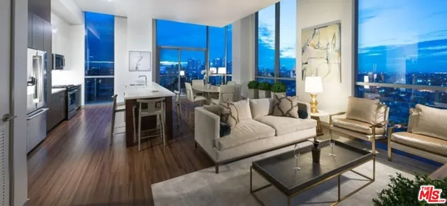 a living room with furniture a fireplace and a dining table with wooden floor