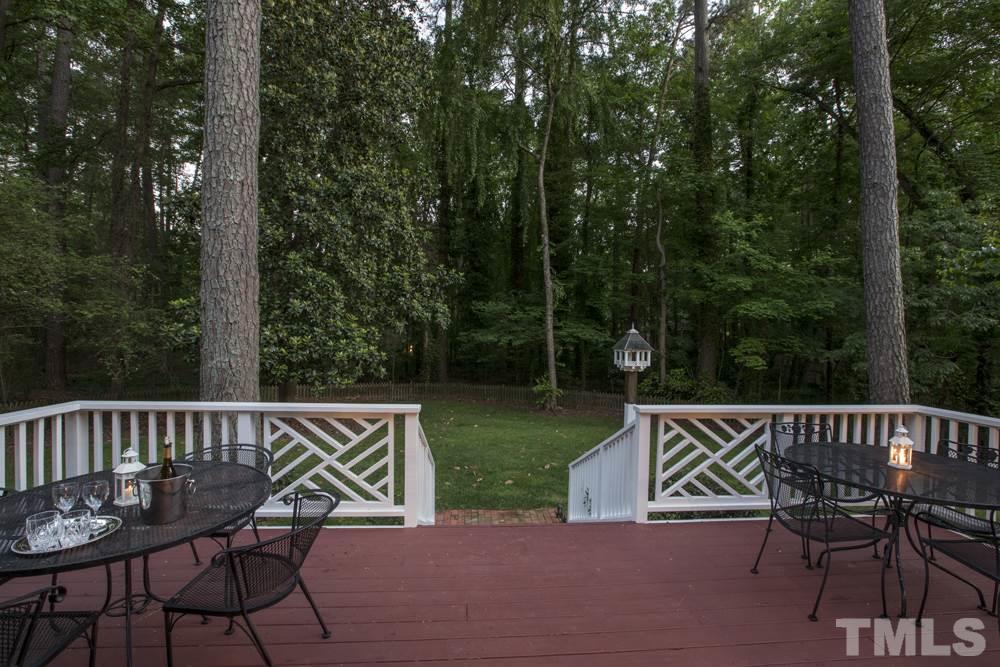 4032 Nottaway Road Durham, NC 27707 - Photo 15 of 25 A large deck with room for several tables, lounges and grill also features a covered porch to the 2-car garage.