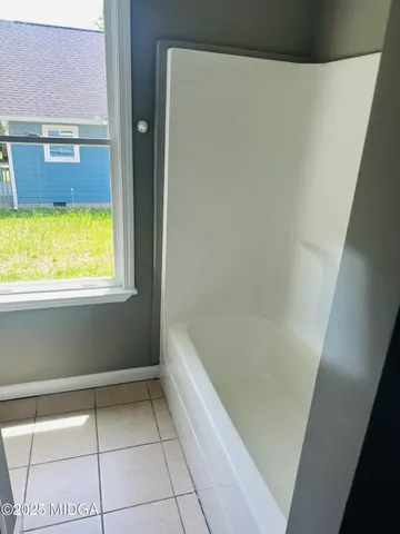 a bathroom with a bathtub and shower