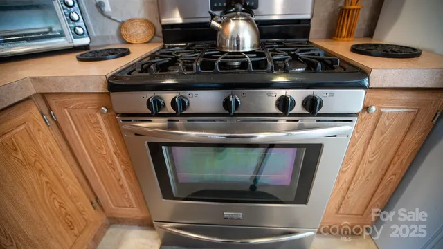 a stove top oven sitting inside of a kitchen
