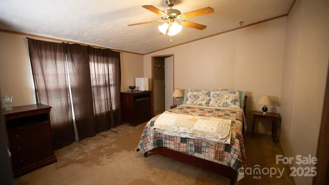 a bedroom with a bed and a refrigerator