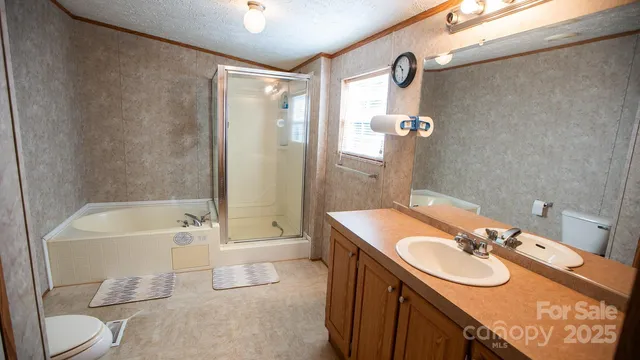 a bathroom with a sink and mirror with bathtub