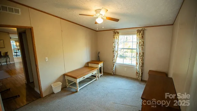 a room with windows and ceiling fan