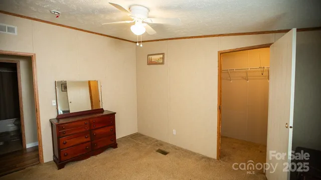 a view of room with wooden floor and ceiling fan