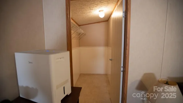 a bed sitting in a bedroom next to a window