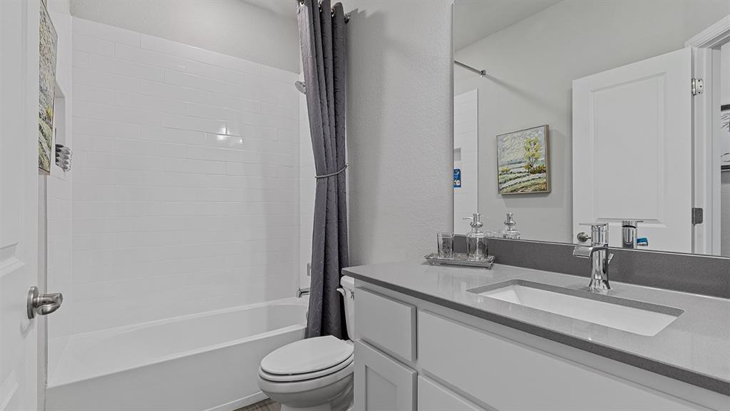 3280 Pier View Street Midlothian, TX 76065 - Photo 23 of 37 a bathroom with a granite countertop sink a toilet and shower