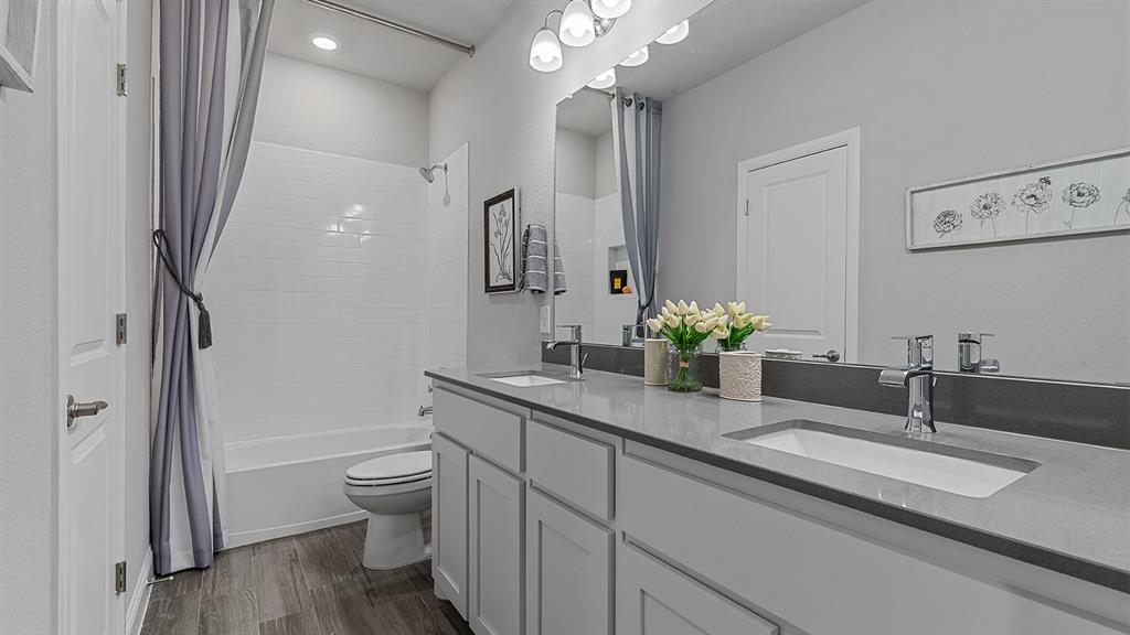 3280 Pier View Street Midlothian, TX 76065 - Photo 31 of 37 a bathroom with a granite countertop sink a toilet and a large mirror