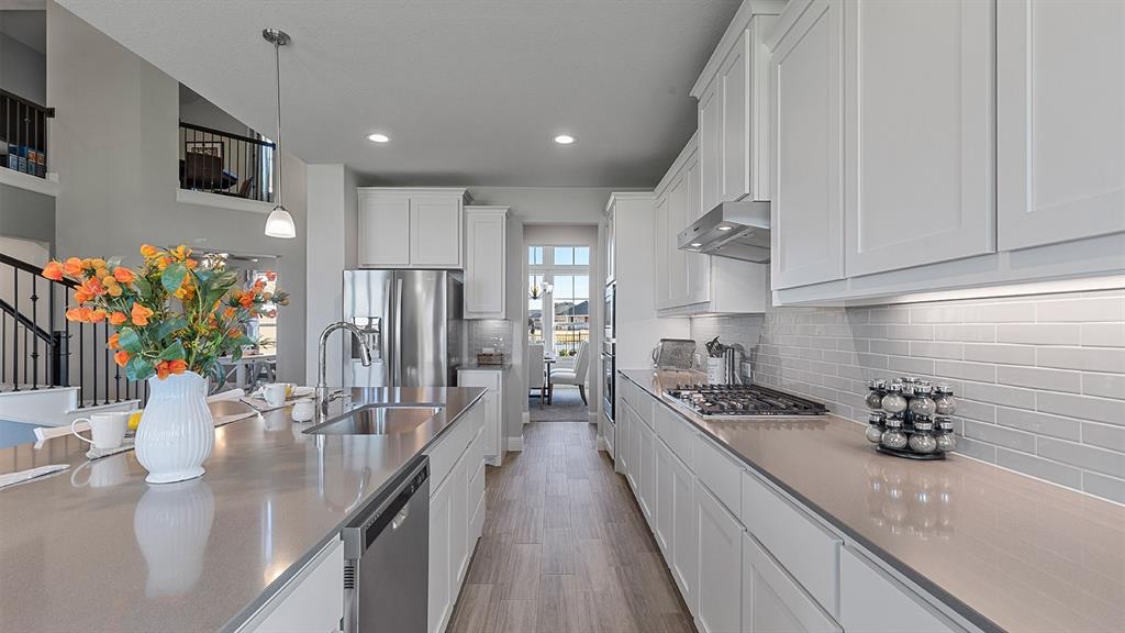 3280 Pier View Street Midlothian, TX 76065 - Photo 5 of 37 a kitchen with stainless steel appliances granite countertop a sink stove and refrigerator