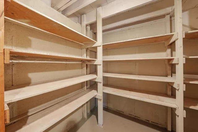 a view of walk in closet with empty racks