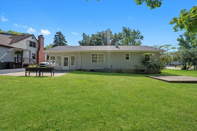 a front view of house with yard and outdoor seating