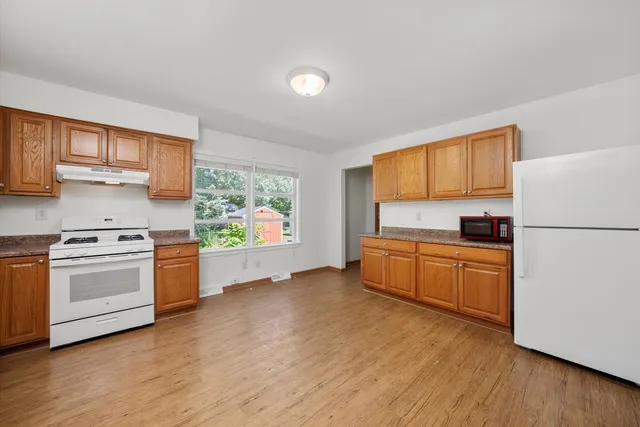 a kitchen with a stove a sink and a refrigerator
