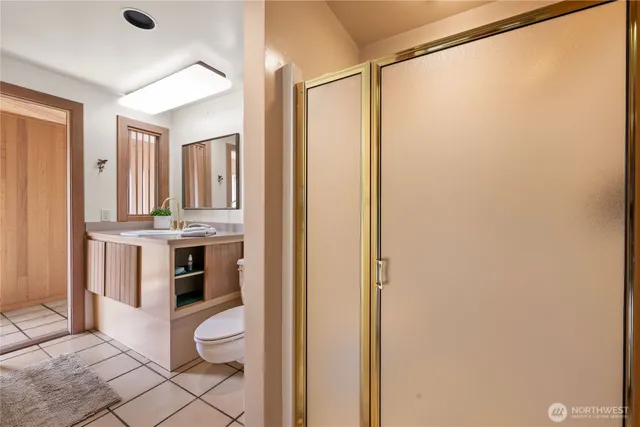 a bathroom with a sink a toilet and shower