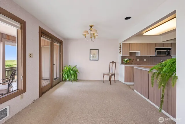 a view of a kitchen with furniture and a potted plant