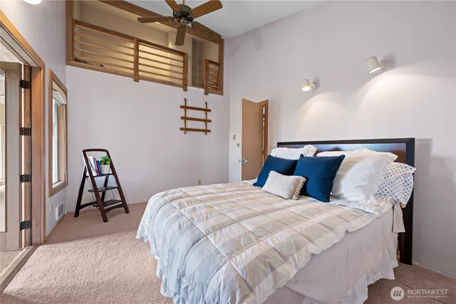 a spacious bathroom with a granite countertop sink a toilet a mirror and shower