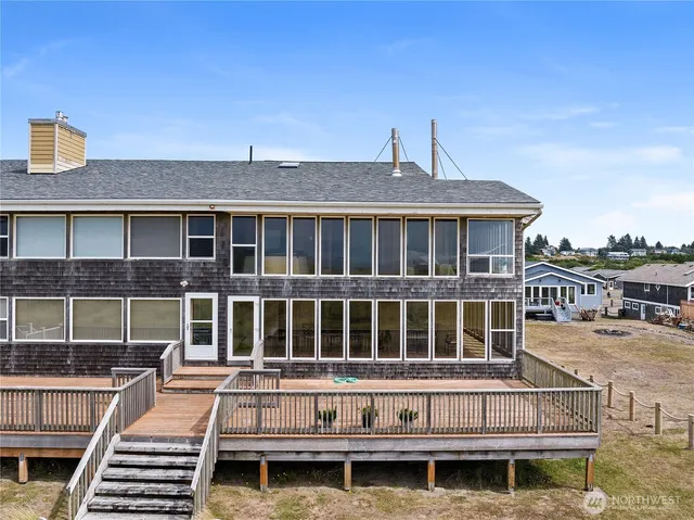 a roof deck with a table and a barbeque