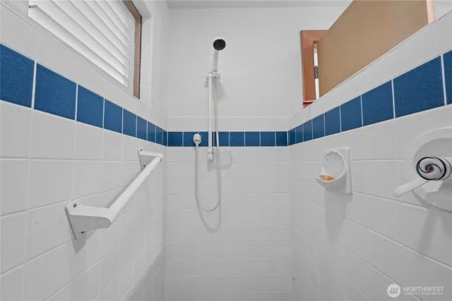 a living room with furniture and floor to ceiling windows