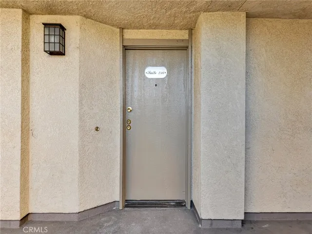 a view of empty room with wooden floor and fireplace