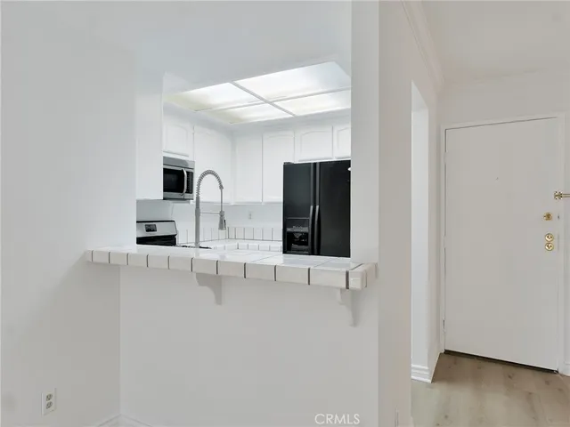 an empty room with wooden floor and a fireplace