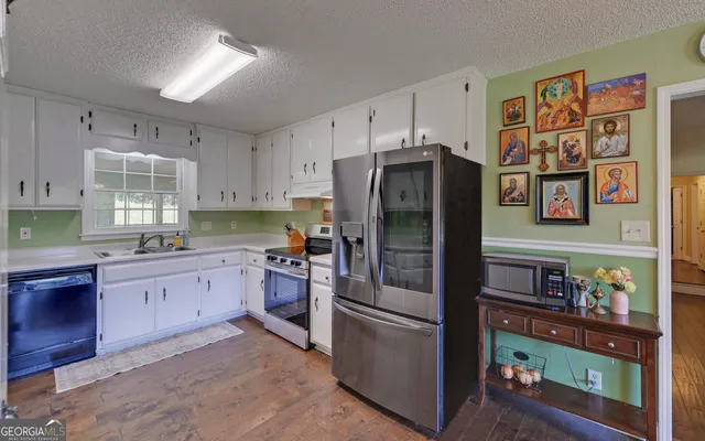 a kitchen with stainless steel appliances a stove a refrigerator and a refrigerator