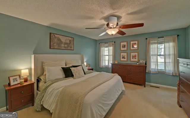 a bedroom with a bed and a television