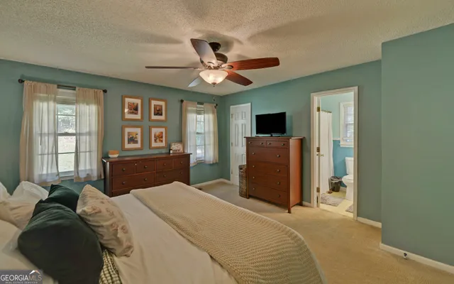 a bathroom with a toilet a sink and a mirror
