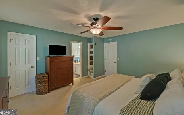 a view of walk in closet with clothes