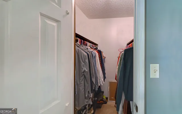 a view of a livingroom with an empty space and windows