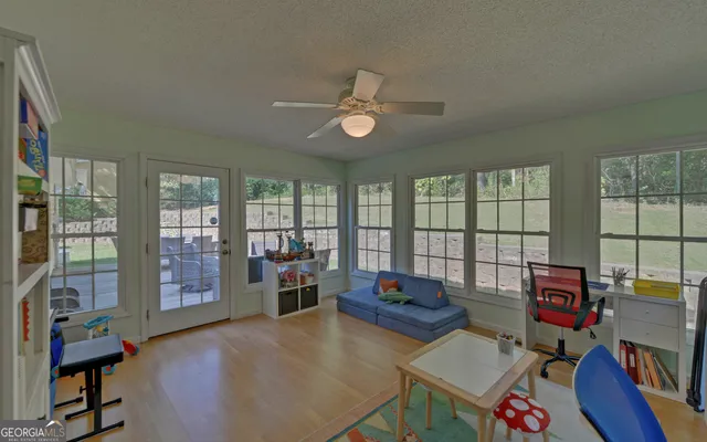 a view of a dining room with furniture and a chandelier