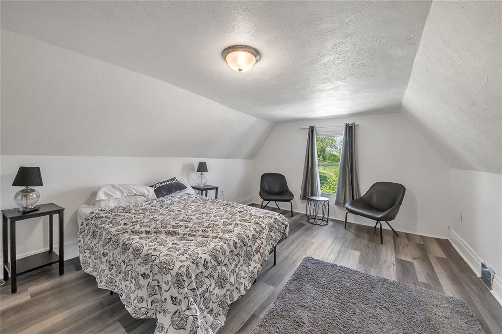 832 Adelaide Street Pittsburgh, PA 15219 - Photo 15 of 24 a living room with a bed furniture and a large window