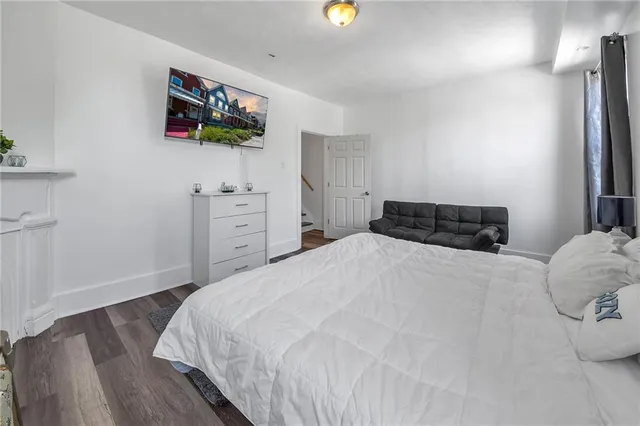 a bedroom with a bed and a dresser