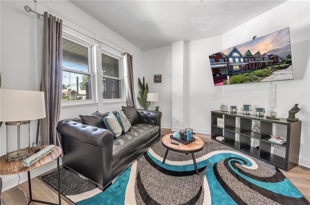 832 Adelaide Street Pittsburgh, PA 15219 - Photo 4 of 24 a living room with furniture and a large window