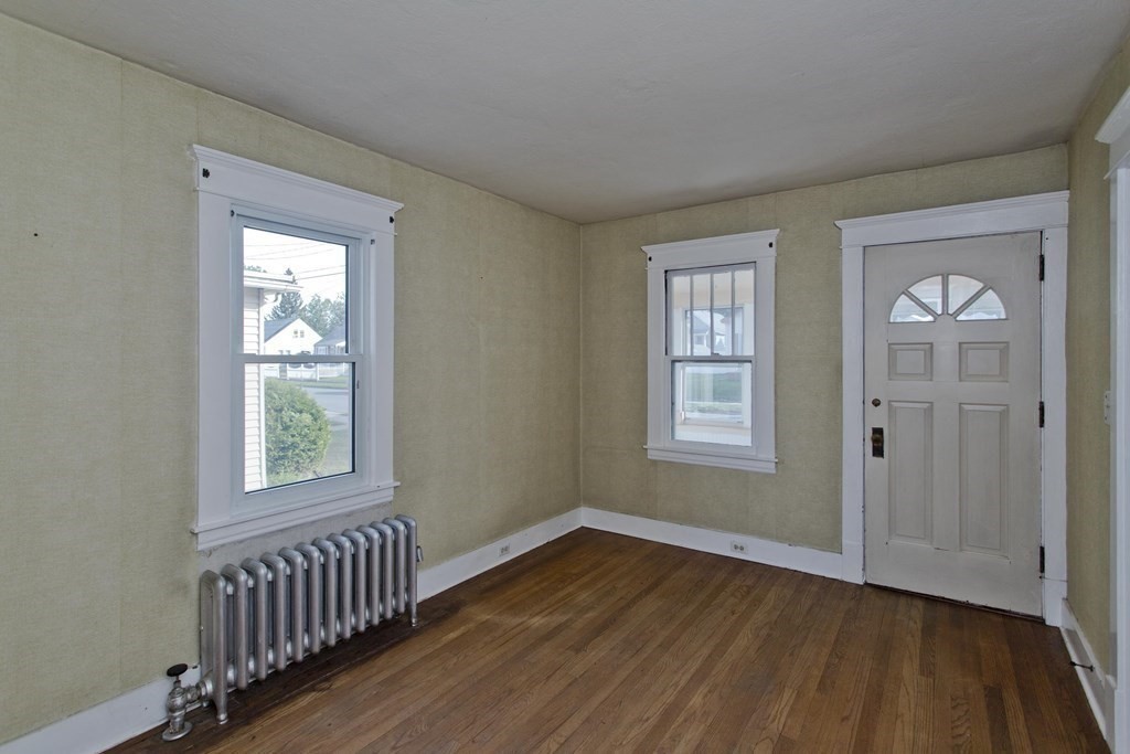 82 Redlands Street Springfield, MA 01104 - Photo 11 of 39 a view of an empty room with wooden floor and a window