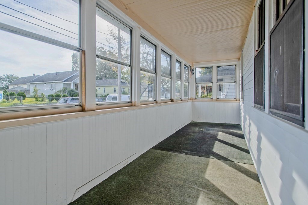 82 Redlands Street Springfield, MA 01104 - Photo 8 of 39 a view of an entryway with wooden floor and windows